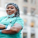 Travel Nurse Smiling Outside of Hospital